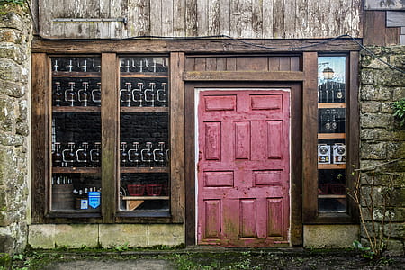 pink wooden panel door during daytime thumbnail
