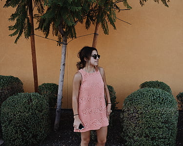 woman under the tree beside plants thumbnail