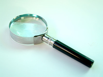silver and black magnifying glass on white desk thumbnail