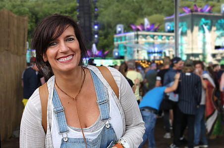 woman in blue denim jumpsuit and white cardigan thumbnail
