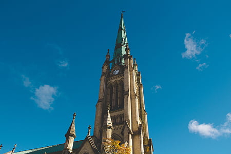 low-angle photography of cathedral under calm blue sky thumbnail