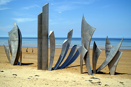 gray wooden blade artworks on shore during daytime thumbnail