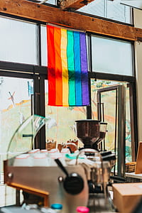 LGBT flag hanging on wall near glass door thumbnail