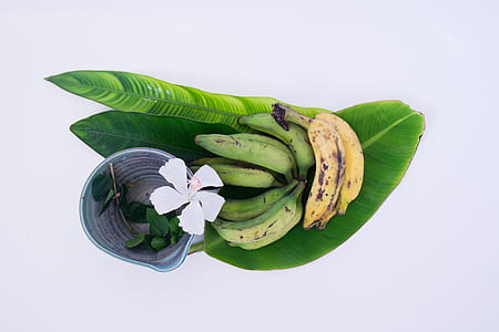 green and yellow bananas on banana leaf thumbnail