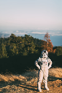 person in Storm Trooper costume standing on ground with green trees background during daytime thumbnail
