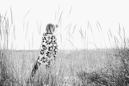 grayscale photo of toddler standing on grass thumbnail