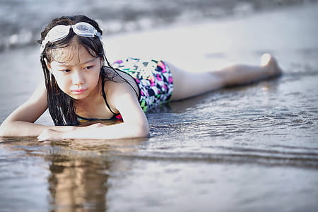 Selective Color Photography of Girl Lying on Beach thumbnail