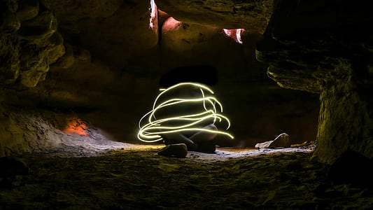 timelapse photography of person inside cave during daytime thumbnail