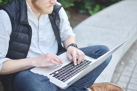 man holding MacBook Air thumbnail