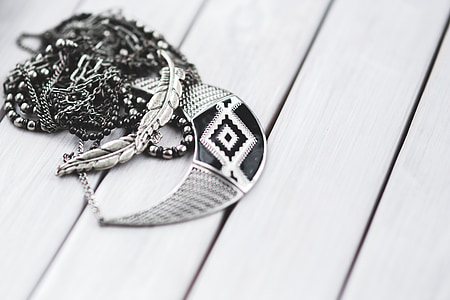 silver-colored necklace on gray surface thumbnail