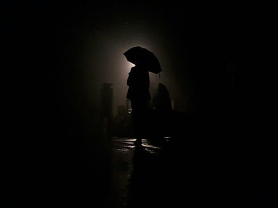 sihlouette photo of person holding umbrella thumbnail