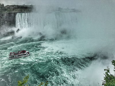 ship near waterfalls during daytime thumbnail
