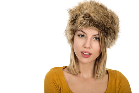 woman wearing brown scoop-neck shirt and brown fur hat thumbnail