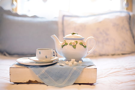 shallow focus photography of white ceramic teapot beside teacup thumbnail