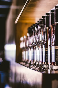 wine bottles with wine glasses on shelf thumbnail
