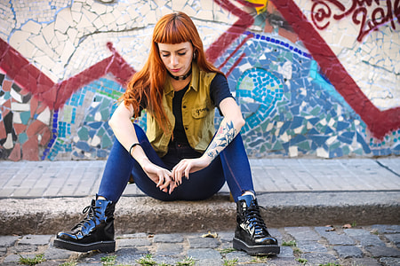 woman sitting on gray concrete pavement thumbnail
