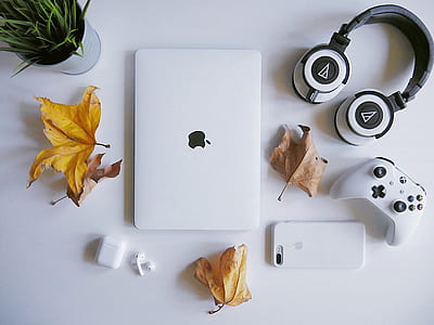 MacBook Pro near white and black wireless headphones thumbnail