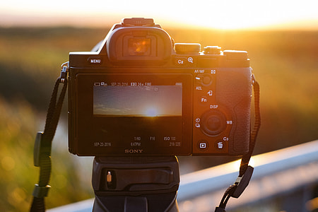 Camera on tripod at sunset thumbnail