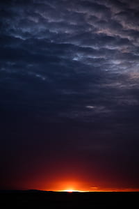 orange sunset with dark clouds thumbnail