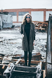 woman wearing cape standing on black metal frame thumbnail