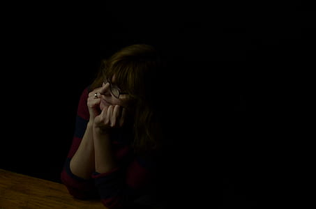 woman sitting beside table thumbnail