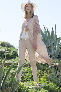 woman standing near green plants thumbnail