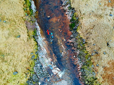 aerial photography of two persons riding on blue and red kayak sailing on river thumbnail