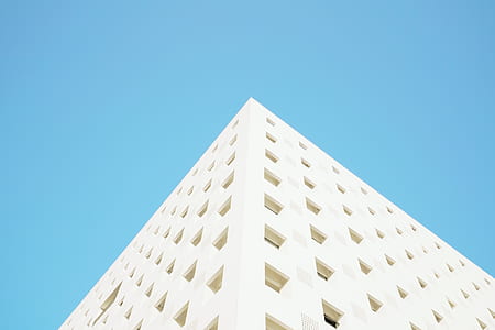 low angle photography of white concrete building at daytime thumbnail