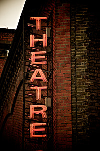 lighted theatre sign on brown building during dayitme thumbnail