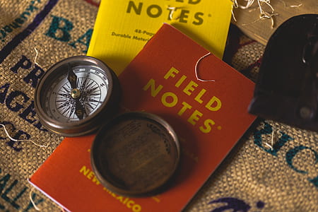 brown wooden compass on book thumbnail