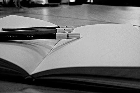 several pens on white book page thumbnail