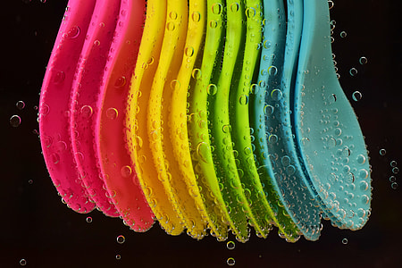 assorted-color spoons in water thumbnail