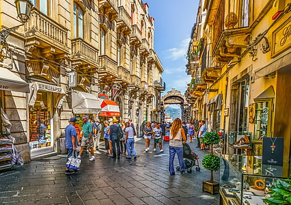 photography of people near brown buildings thumbnail