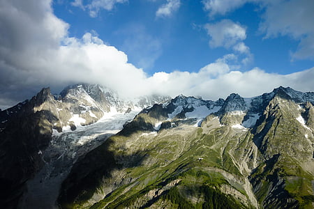 aerial photo of snow covered mountain during daytime thumbnail