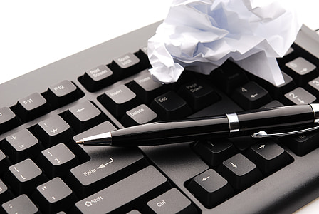 black retractable pen on computer keyboard thumbnail