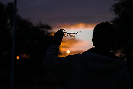 person holding eyeglasses thumbnail