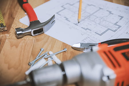 Hammer and other tools with an apartment plan thumbnail