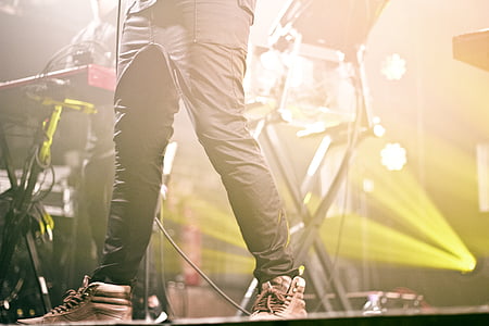 person standing on stage near drum thumbnail