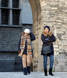 two women walking standing near gray arc thumbnail