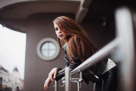 woman in black leather jacket staring at terrace thumbnail