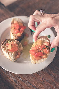 Person Holding Cooked Food Near White Plate thumbnail