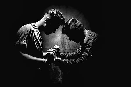 Grayscale Photo of Two Men Holding Hands thumbnail