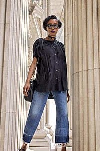 standing woman wearing black button-up shirt thumbnail