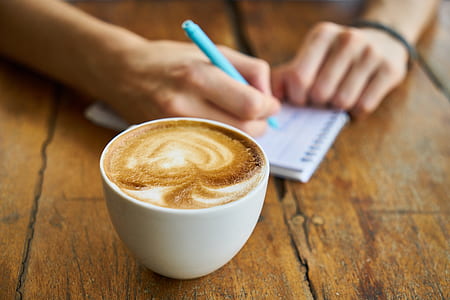 white ceramic teacup filled by coffee thumbnail