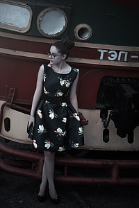 woman wearing black and white floral sleeveless dress thumbnail