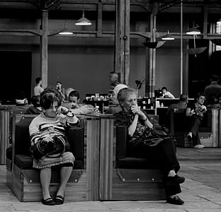two woman sitting on chairs thumbnail