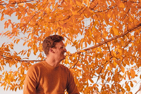 man in orange sweater smiling thumbnail