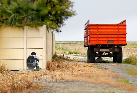 orange dropside truck near fence thumbnail