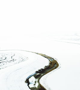 body of water surrounded by snow thumbnail
