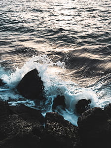 ocean waves hammering rock boulder thumbnail